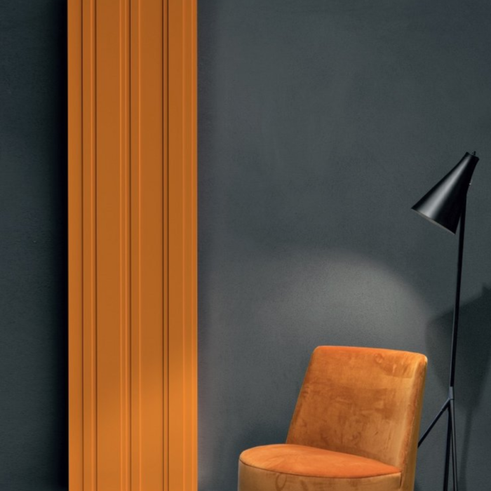 Design scultoreo del termoarredo Bitlight di Antonio Lupi contro parete di piastrelle azzurre, accanto a box doccia moderno